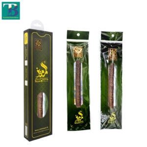 Two thick olive miswak sticks side by side, freshly harvested, with natural bark and trimmed tips ready for use.