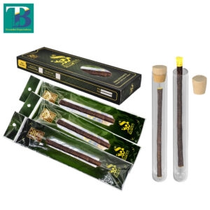 Three premium olive miswak sticks with two transparent glass holders for natural oral care and fresh breath.
